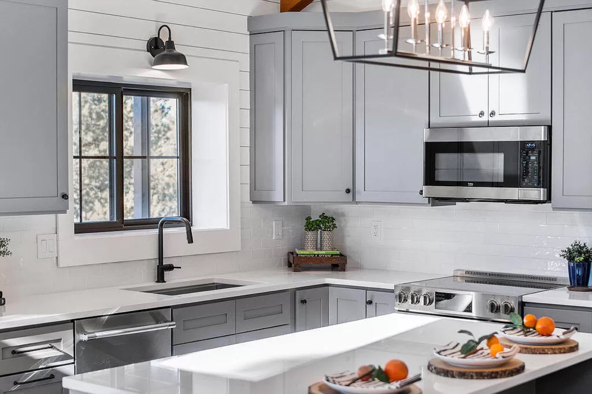 Bright kitchen with shiplap detailing, exposed beams, and an island
